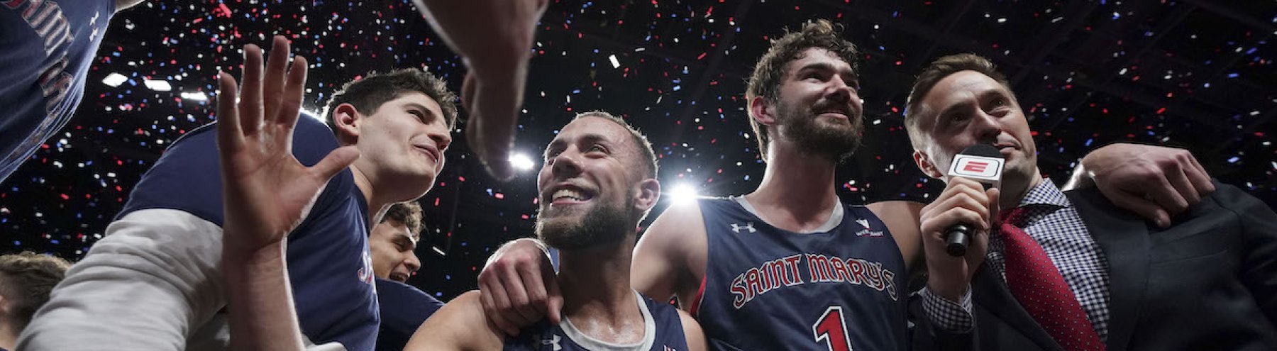 Jordan Ford and teammates high five at the WCC Championship