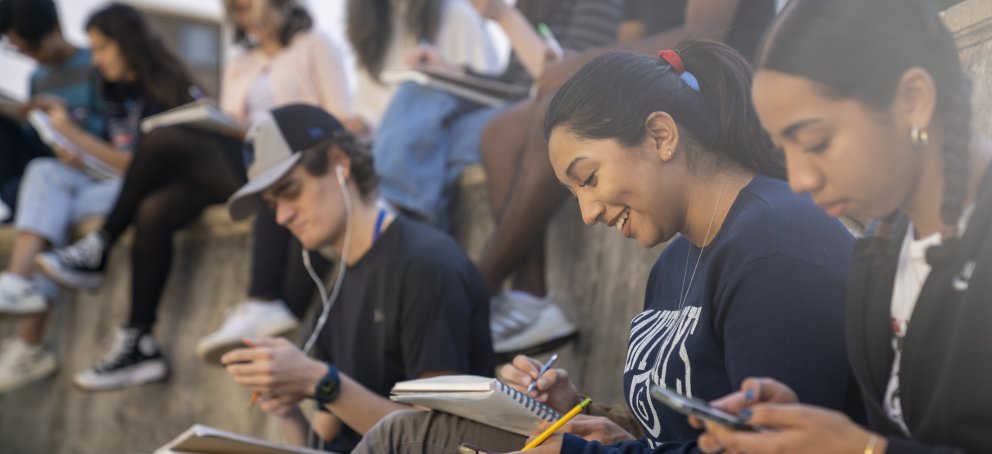 Student sitting in an a lecture class in outside