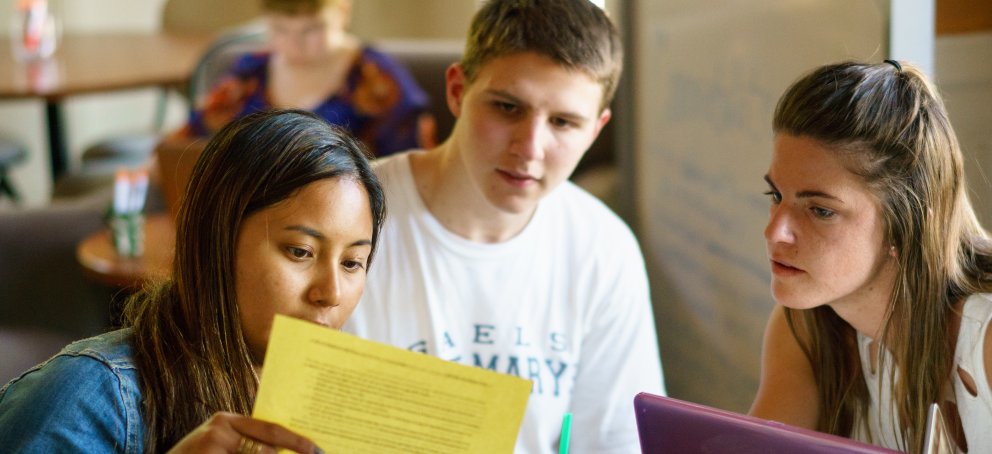 Students discussing a paper in the Writing Center.