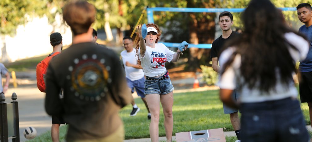 Students playing cornhole
