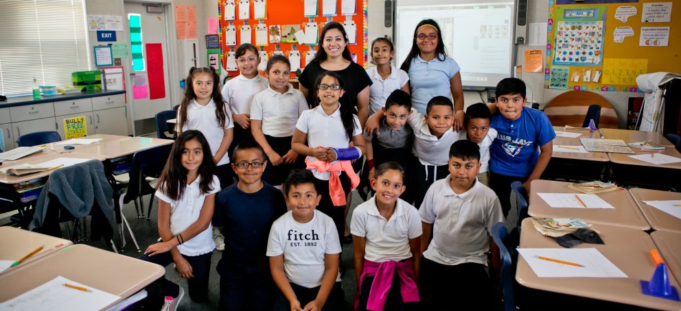 A teacher standing with her class