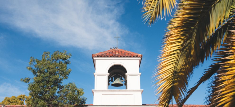chapel in front of blue sky and foliage