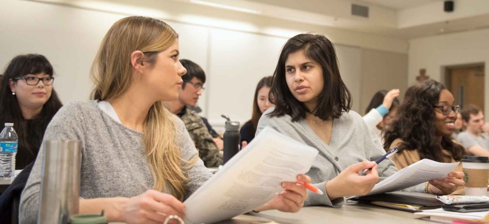 Students in an accounting class talking to each other