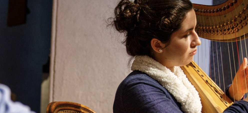 Female student playing the harp