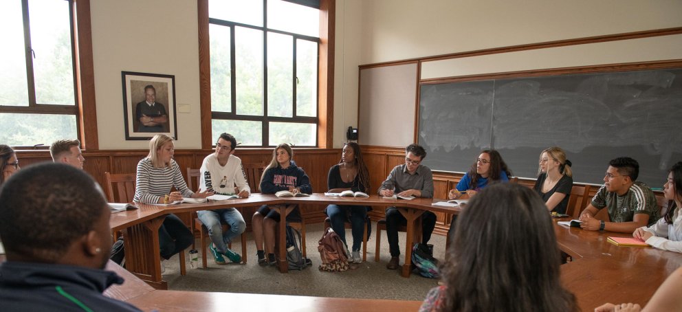 Students seating around a seminar table