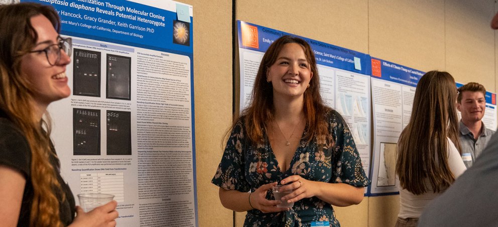 three people talking in front of wall
