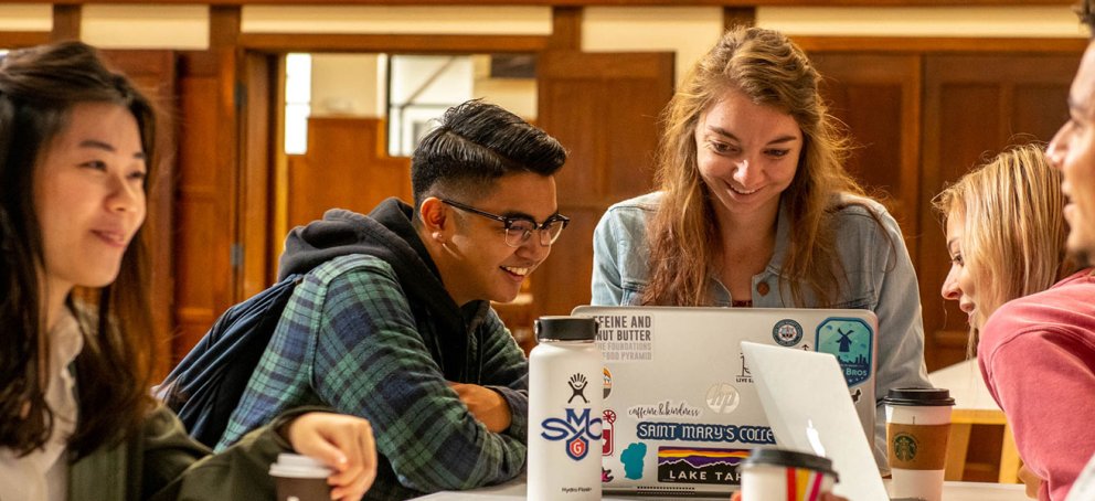 five students smiling inside