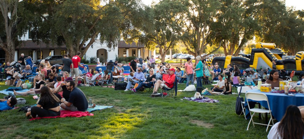 Hundreds of people sit on lawn chairs at Music on the Lawn