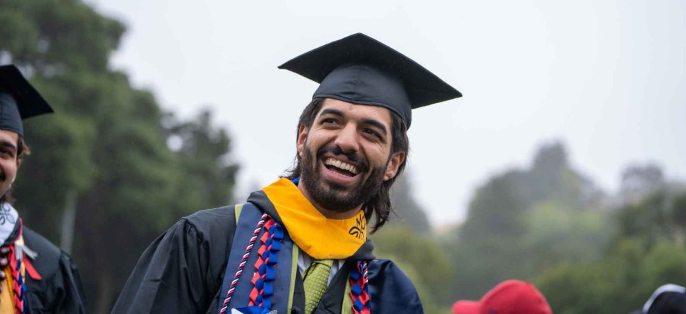 A saint mary's college graduate at commencement with his graduation cap on