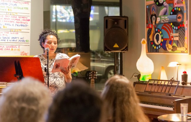 A writer performs her work for an audience
