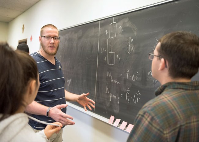 students at a chalk board doing math