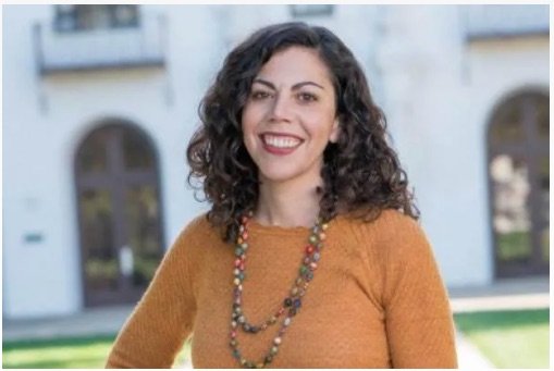 Headshot of Prof. Emily Klein in front of De La Salle Hall