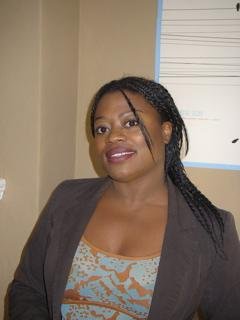 Headshot photo of Prof. Jeannine King in her office window in background