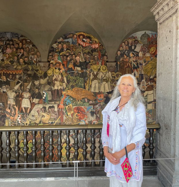 Professor Santiago in front of decorative wall