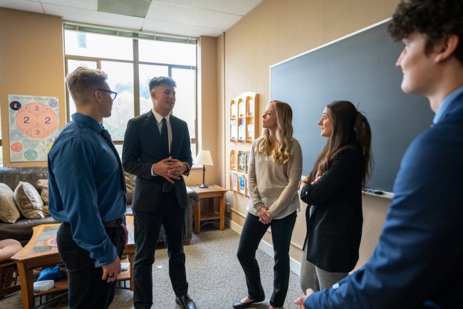 Students from the 2024 Lasallian Business Ethics Competition discuss their strategy after winning