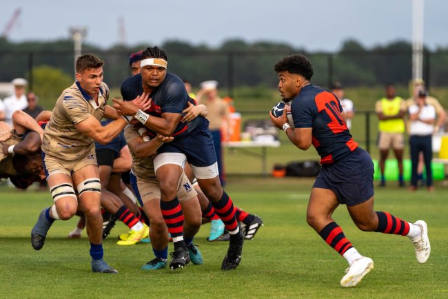Rugby players Inoke Waqevesi and King Matu battle against Navy defenders in 2024 National Championship