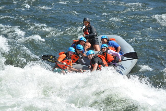 Brace Yourself: Participants lean into the raft to brace for the Class III rapid known as Hospital Bar on the South Fork of the American River. / Photo courtesy of  Hotshot Images