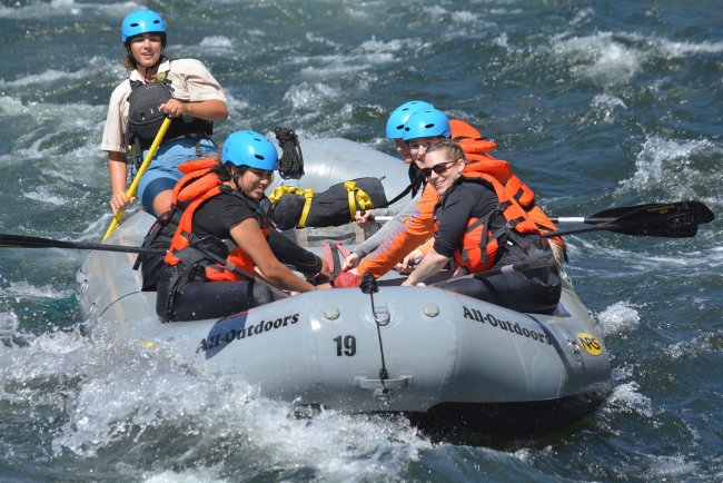 Hold On: Participants prepare for turbulent waters and hold on as the raft guide instructs them for the rapid ahead.  / Photo courtesy of Hotshot Images