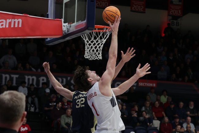 Men's Basketball player Harry Wessels sinks the ball against Akron on November 12, 2024