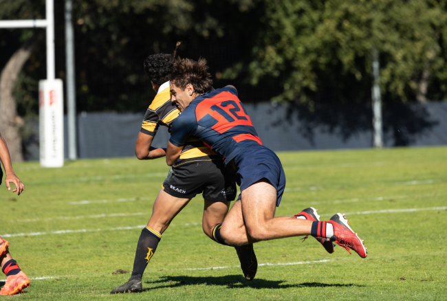 Ethan Younger Tackles the Long Beach State player during the rugby match