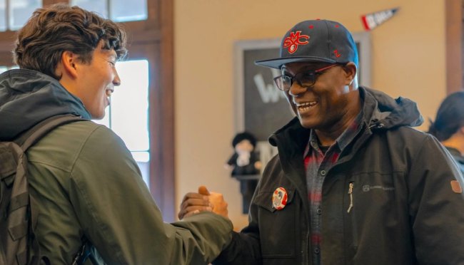 Father Kwame Assenyoh and a student at the February 2024 Meet and Greet