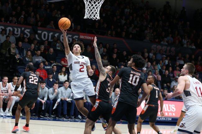 Men's basketball player Jordan Ross shoots against Pacific