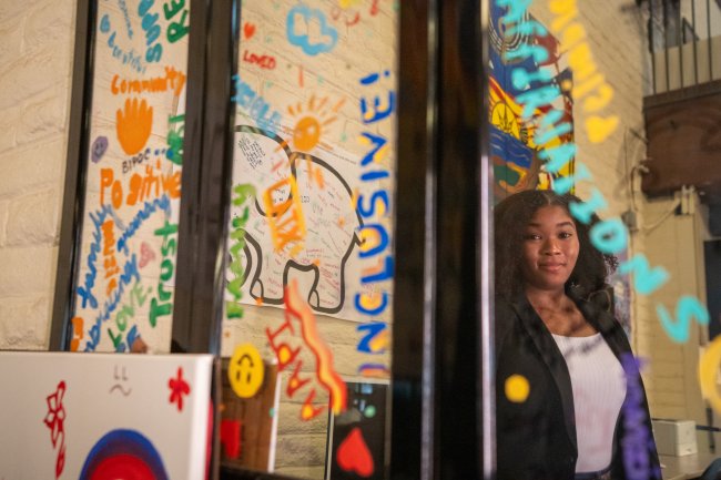 Alexis Hackett poses looking at mirror in the Intercultural Center