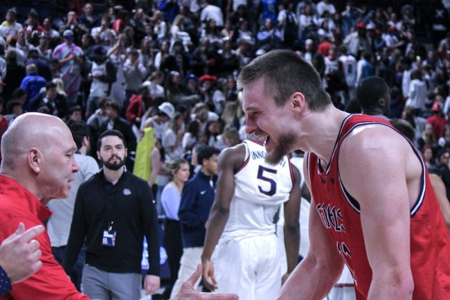 Men's Basketball player Mitchell Saxen celebrates with Head Coach Randy Bennett after win over Gonzaga in February 2025