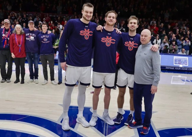 Three men's basketball seniors and Head Coach Randy Bennett on court on March 1, 2025