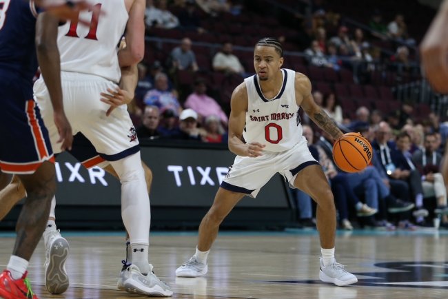 Men's Basketball Player Mikey Lewis looks for an opening against Pepperdine in 2025 WCC Semifinals