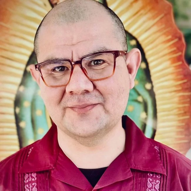 Headshot of Javier Hurtado behind a picture of the Virgen de Guadalupe