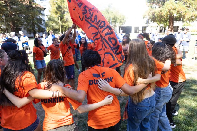 Rally Together: Assumption Hall waves their hall with pride while circled together in unity during the opening ceremonies of the First Year Olympics. / Photo by Rebecca Harper