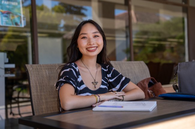 Isabelle Ly sitting outside library