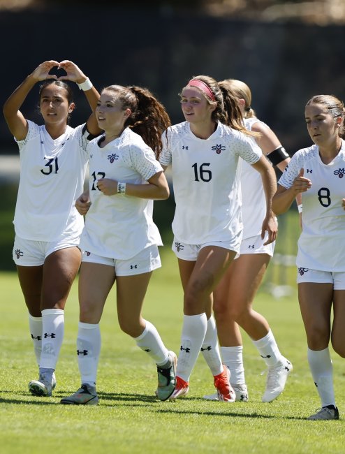 Five women soccer players running and celebrating, fall 2025