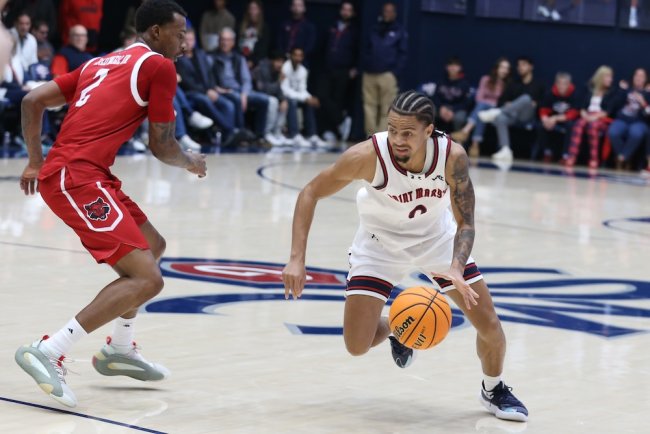 Basketball player Mikey Lewis drives against Arkansas State in November 2025