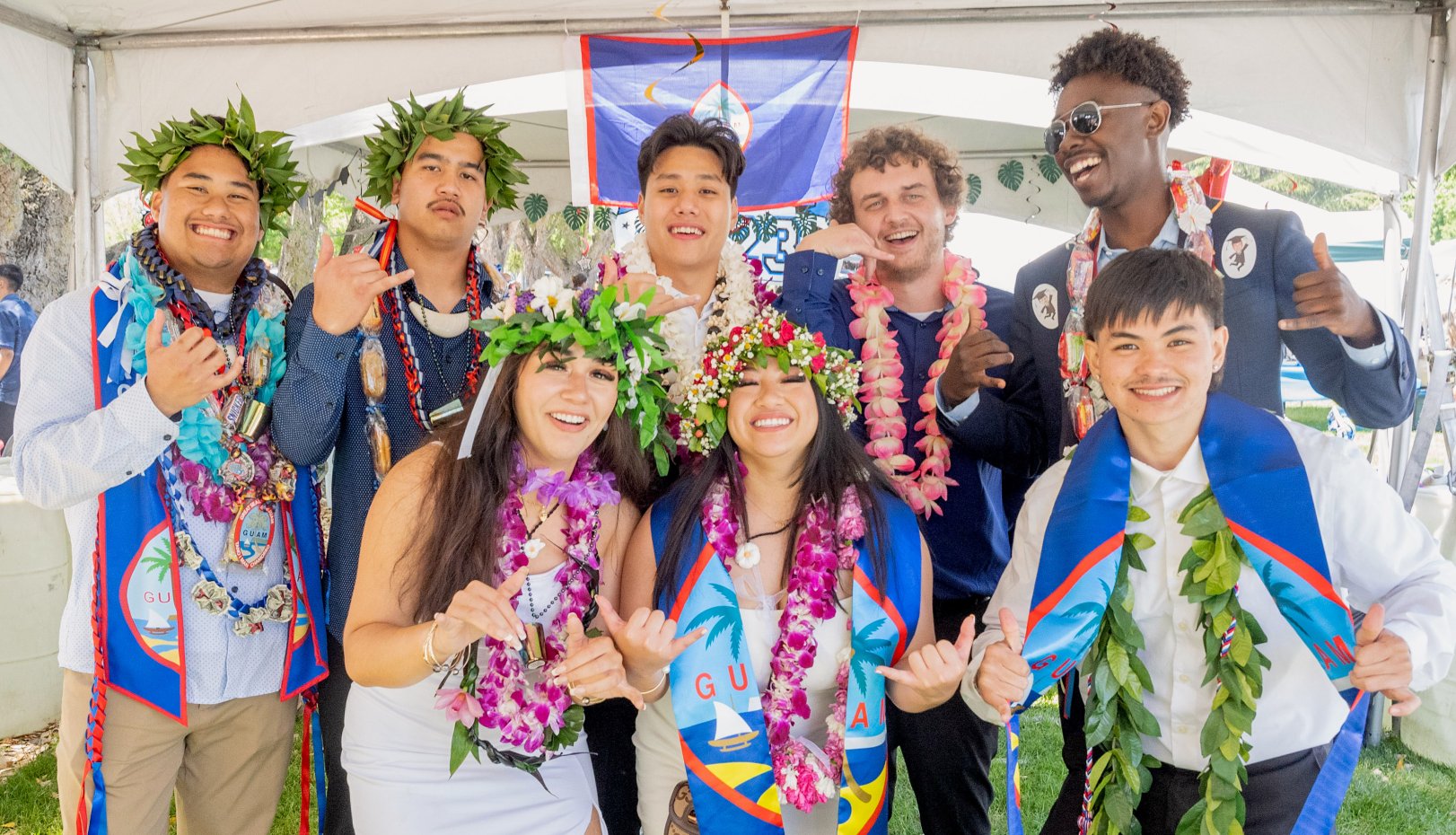 Group of grads under tent