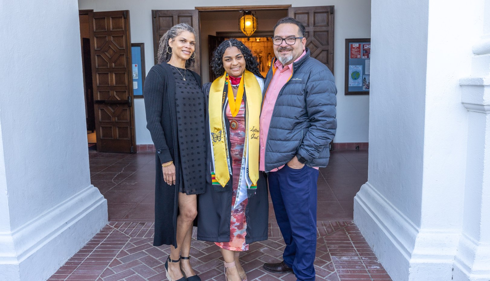 Grad and parents at Latinx Grad Celebration