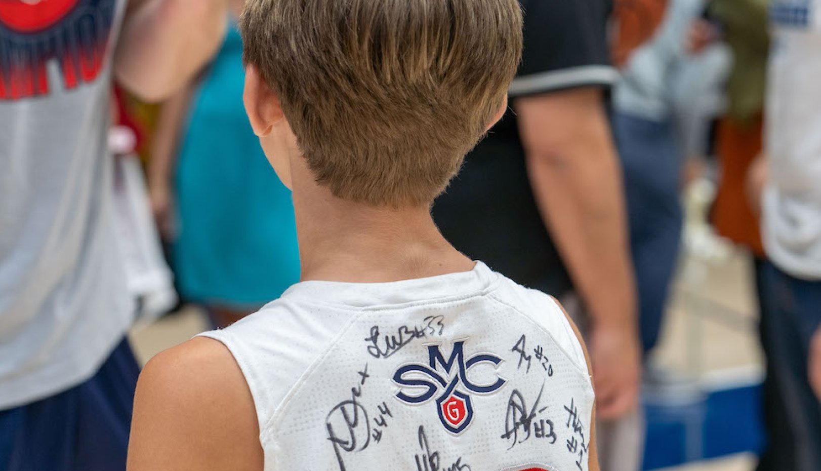 Young fan with signed jersey at 2024 NCAA Selection Sunday
