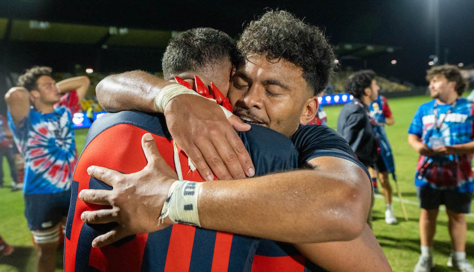 SMC Men's Rugby player Inoke Waqevesi Jr. hugs a teammate after winning 2024 National Championship