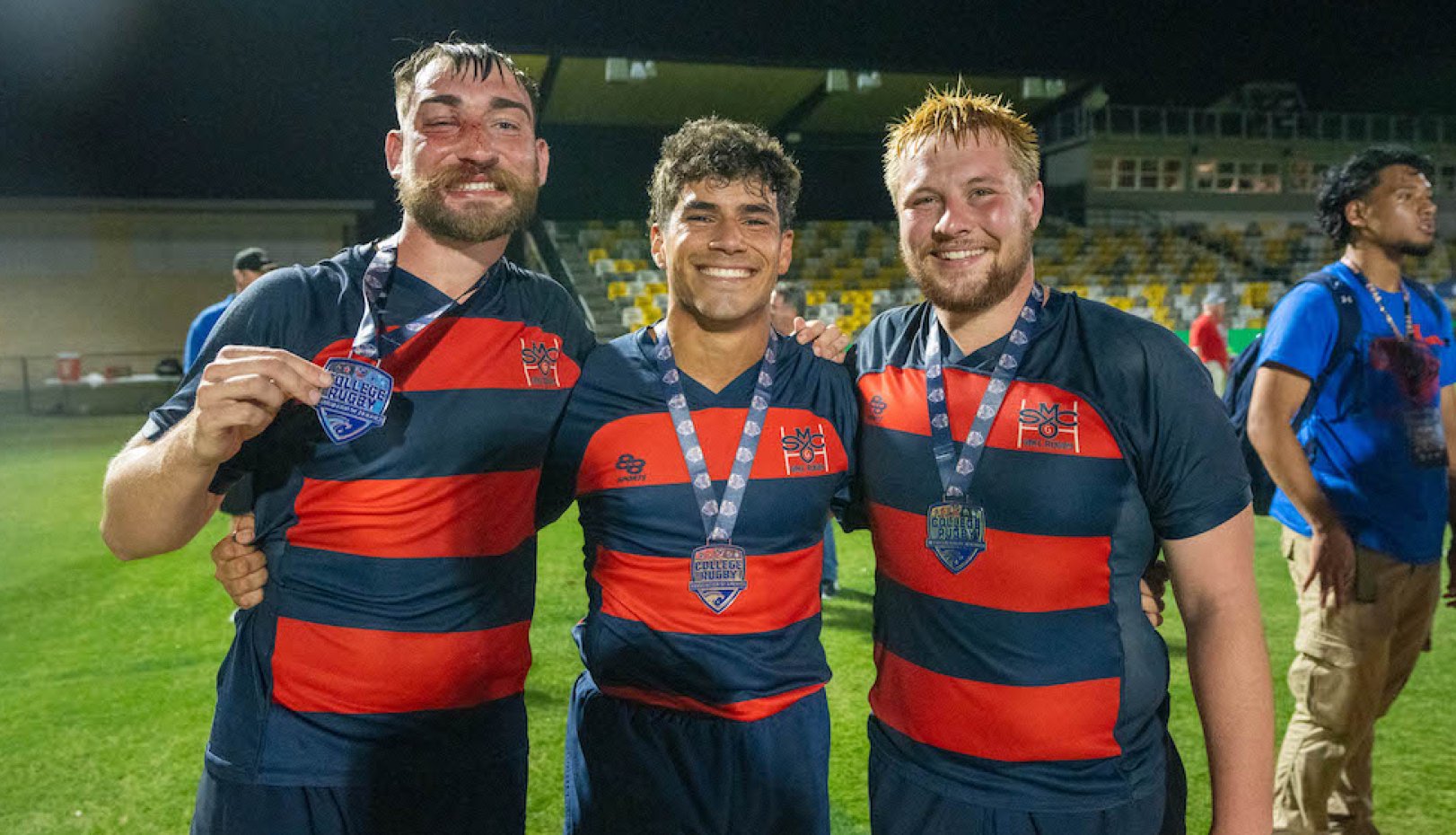 Three Saint Mary's men's rugby players celebrate winning 2024 National Championship