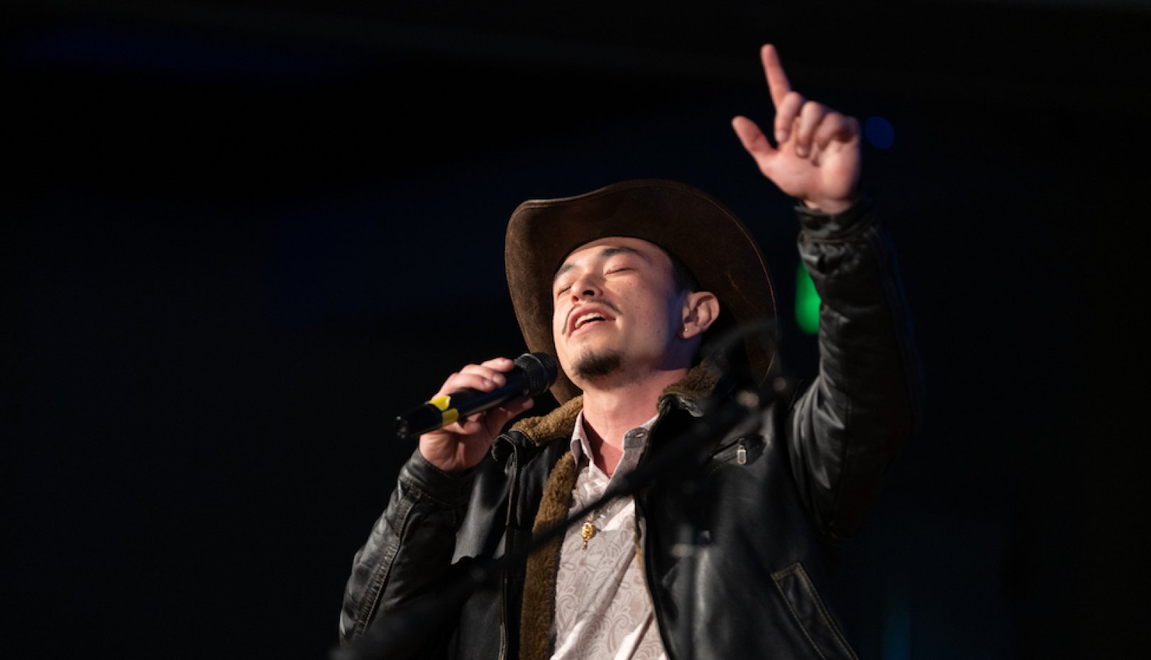 Male student singing at Cultural Showcase 2024