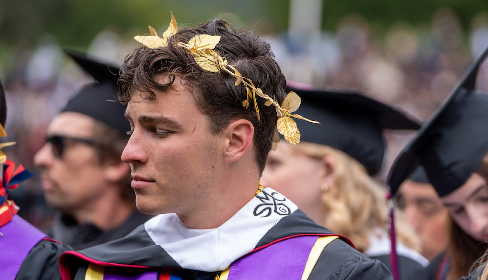 A student wearing a wreath of laurel leaves at 2024 Undergraduate Commencement
