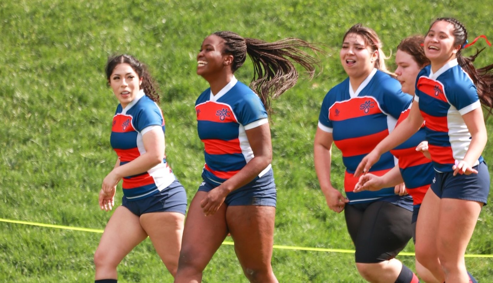 women's rugby team on the turf in 2025