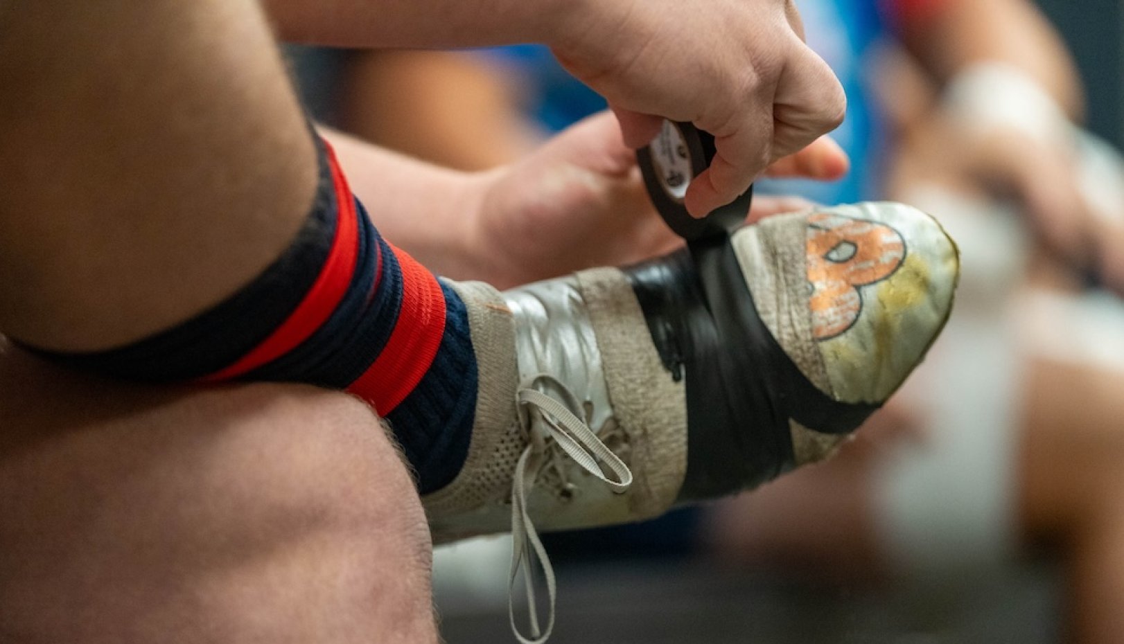 A Gael player tapes his boots before the 2024 Rugby National Championship