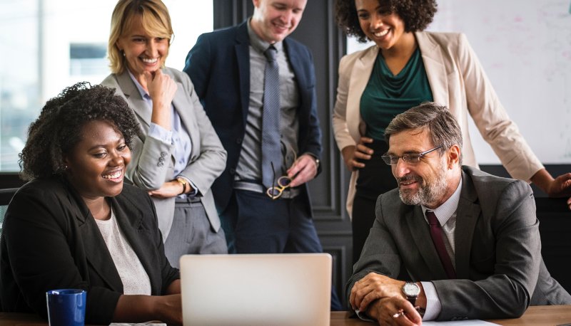Office workers looking at a laptop presentation