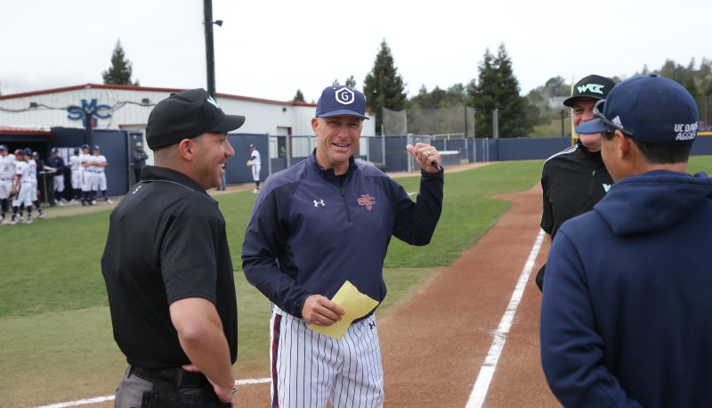 SMC Baseball Coach Greg Moore meets with the umpires before a game