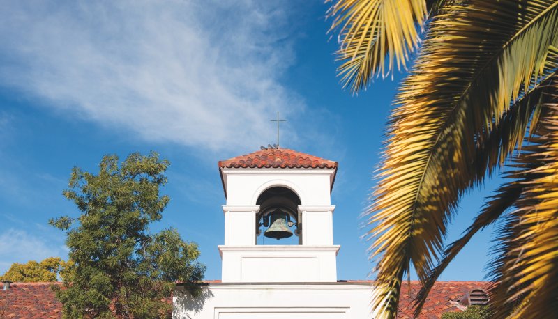 chapel in front of blue sky and foliage