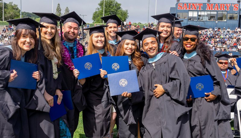 Graduate students hold their diplomas and celebrate at Saint Mary's 2023 Commencement