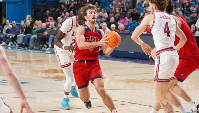 Men's basketball player Augustas Marciulionis drives against LMU in January 2024