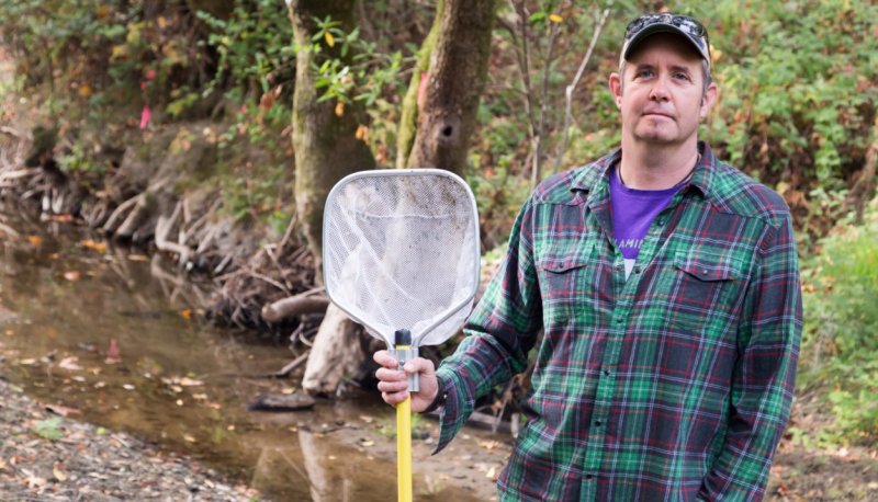 Michael Marchetti out in the field holding a net